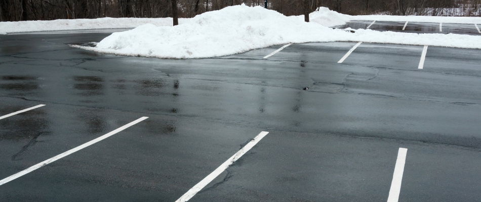 Cleared commercial parking lot with plowed snow in St. Peter, MN.