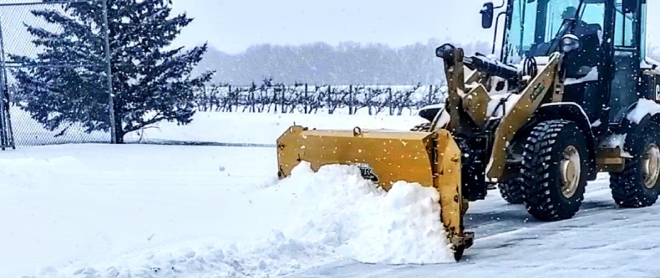 Commercial plow clearing a business parking lot in North Mankato, MN.