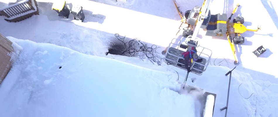 Storm technician operating equipment to remove ice buildup in North Mankato, MN.